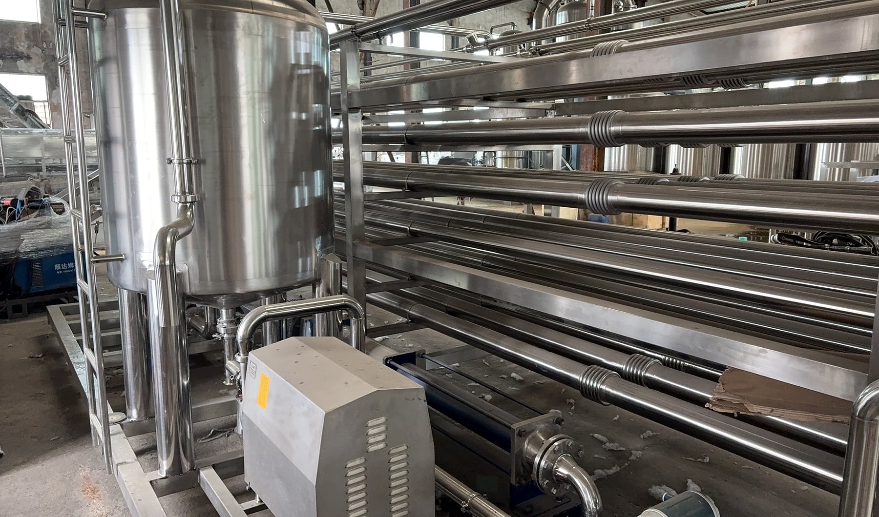 Sanitary tube-in-tube sterilization equipment installed on a processing line